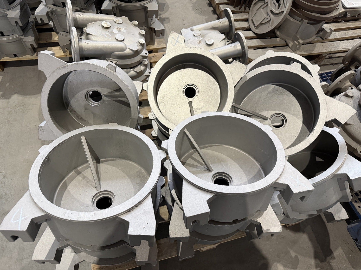 Batch of metal components staged for inspection and finishing