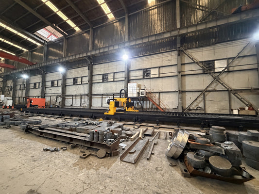 Long-format plate cutting table in metal fabrication workshop