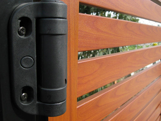 Black gate hinge mounted beside a horizontal slat gate
