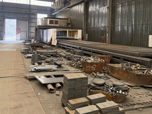 Large cut metal blanks staged for fabrication