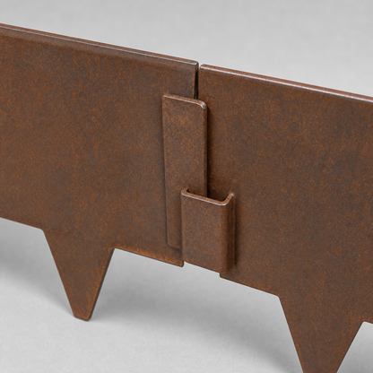 Close-up of inside pin-and-pocket end connector for one-piece corten metal landscape edging
