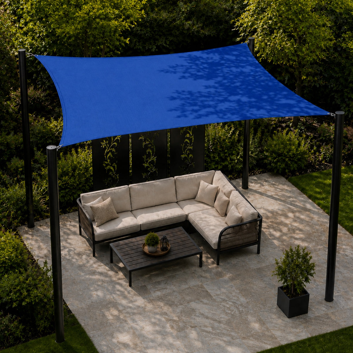 Square outdoor shade sail installed over a garden patio seating area