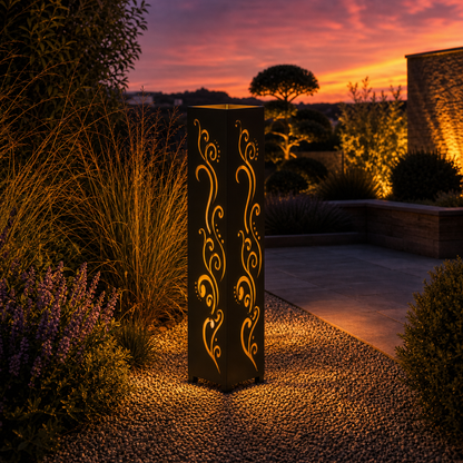 Design 010 outdoor decorative LED light column glowing at dusk in garden setting