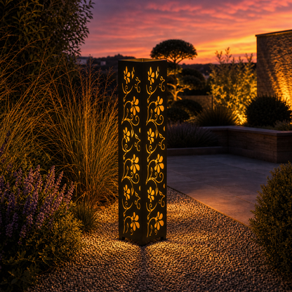 Design 012 outdoor decorative LED light column glowing at dusk in garden setting