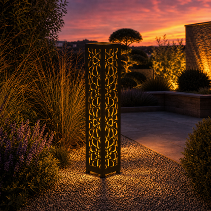 Design 016 outdoor decorative LED light column glowing at dusk in garden setting