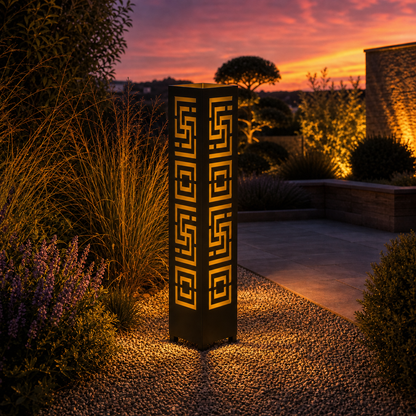 Design 019 outdoor decorative LED light column glowing at dusk in garden setting