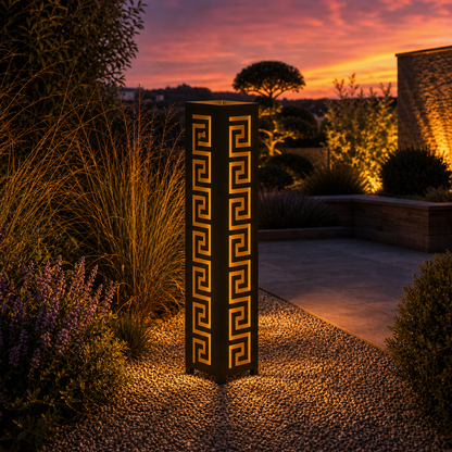 Design 022 outdoor decorative LED light column glowing at dusk in garden setting