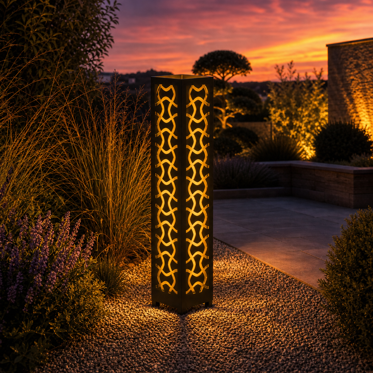 Design 025 outdoor decorative LED light column glowing at dusk in garden setting
