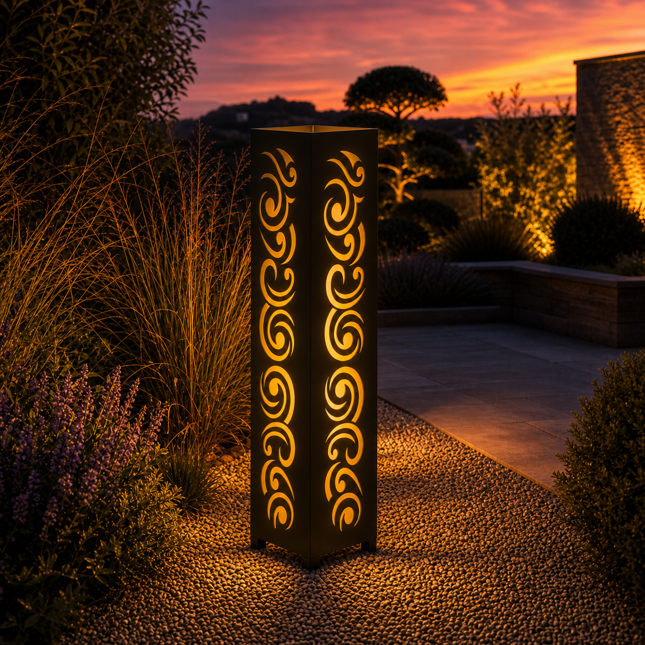 Design 030 outdoor decorative LED light column glowing at dusk in garden setting