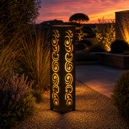 Design 030 outdoor decorative LED light column glowing at dusk in garden setting
