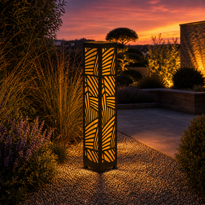 Design 031 outdoor decorative LED light column glowing at dusk in garden setting