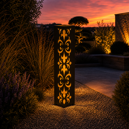 Design 033 outdoor decorative LED light column glowing at dusk in garden setting