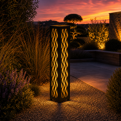 Design 037 outdoor decorative LED light column glowing at dusk in garden setting