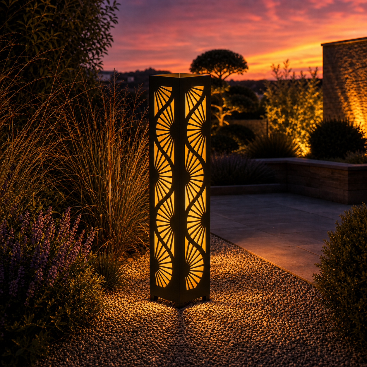 Design 038 outdoor decorative LED light column glowing at dusk in garden setting