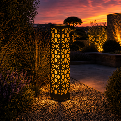 Design 044 outdoor decorative LED light column glowing at dusk in garden setting