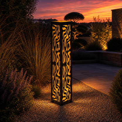 Design 065 outdoor decorative LED light column glowing at dusk in garden setting
