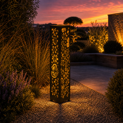 Design 096 outdoor decorative LED light column glowing at dusk in garden setting