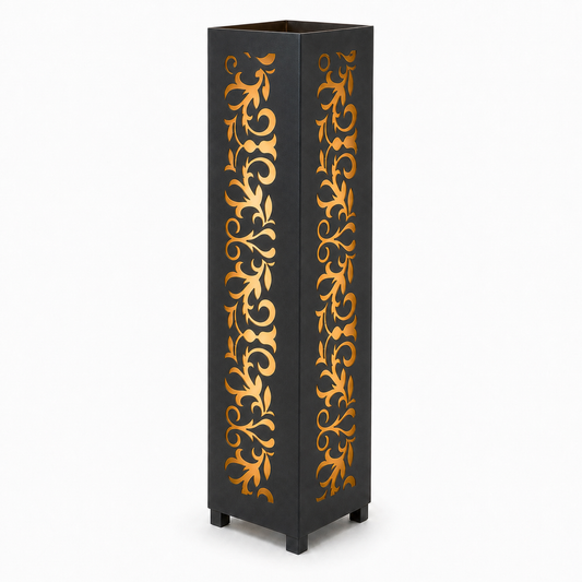 Design 101 black laser cut metal garden light tower with warm LED glow on white background