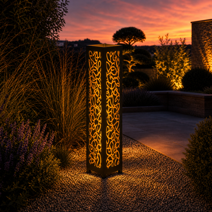 Design 102 outdoor decorative LED light column glowing at dusk in garden setting