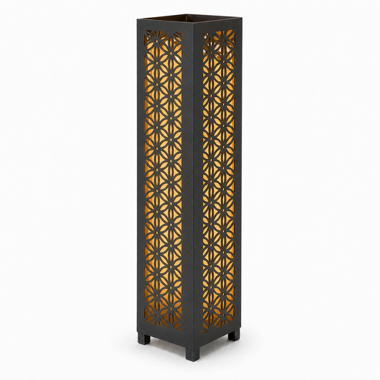 Design 106 black laser cut metal garden light tower with warm LED glow on white background