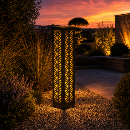 Design 106 outdoor decorative LED light column glowing at dusk in garden setting