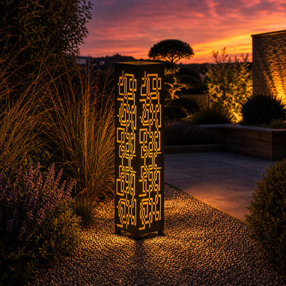 Design 114 outdoor decorative LED light column glowing at dusk in garden setting