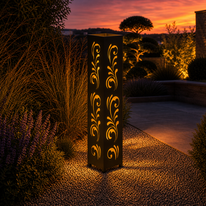 Design 117 outdoor decorative LED light column glowing at dusk in garden setting