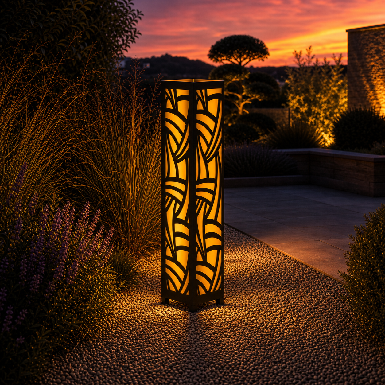 Design 125 outdoor decorative LED light column glowing at dusk in garden setting