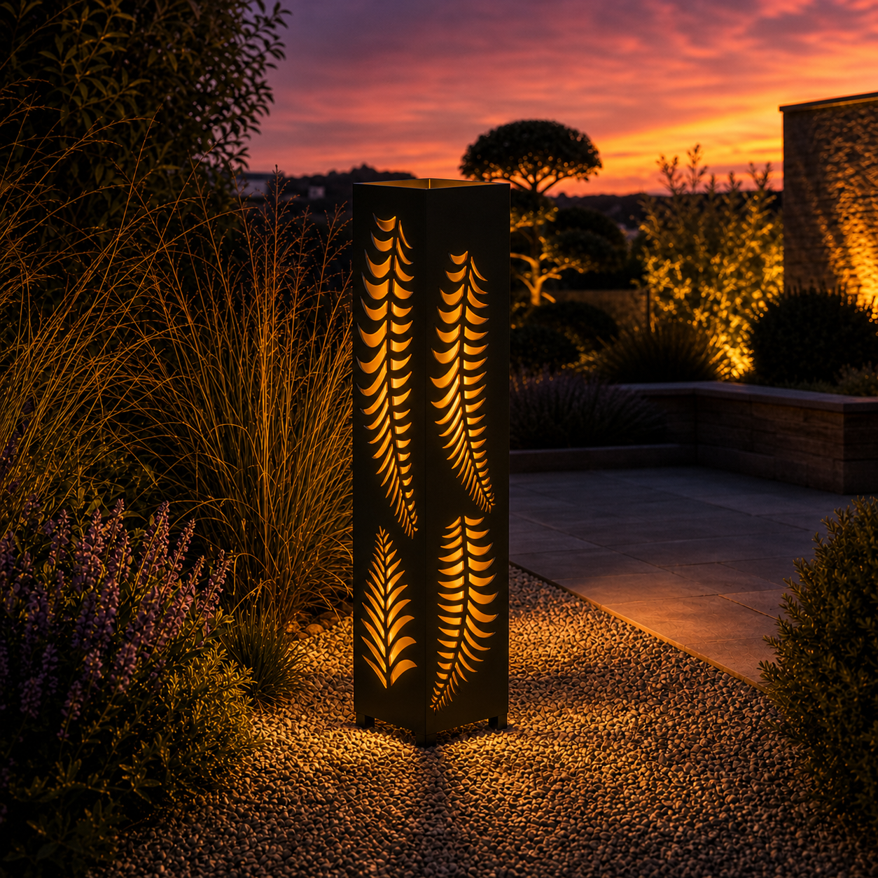 Design 133 outdoor decorative LED light column glowing at dusk in garden setting