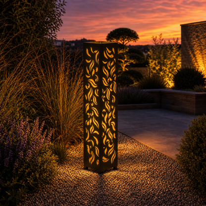 Design 135 outdoor decorative LED light column glowing at dusk in garden setting