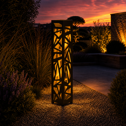 Design 138 outdoor decorative LED light column glowing at dusk in garden setting