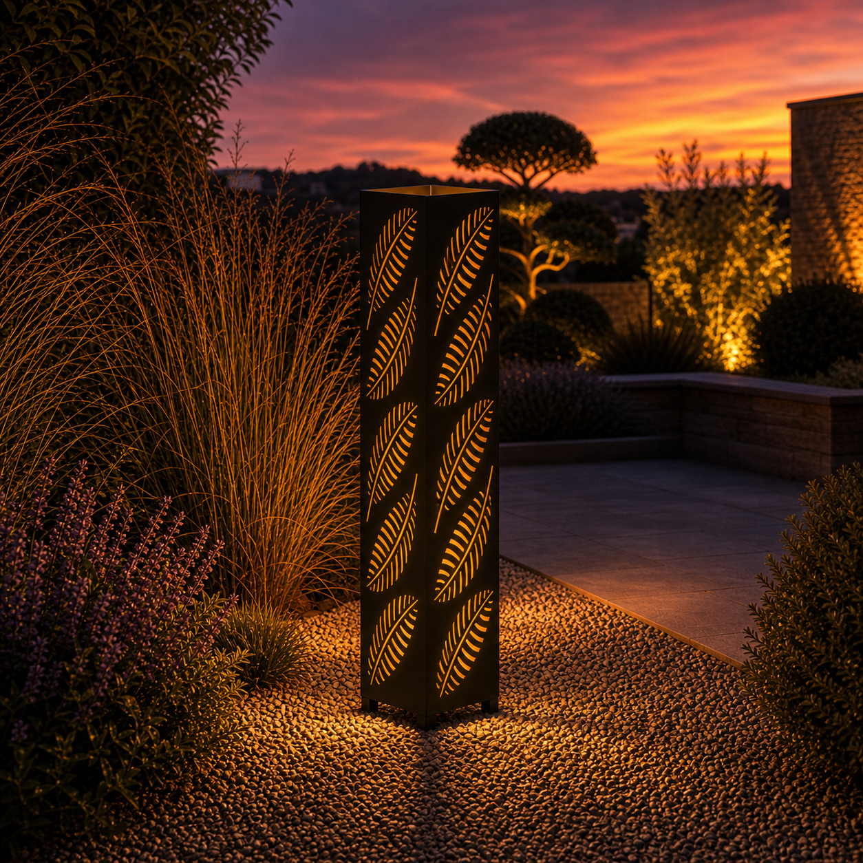 Design 143 outdoor decorative LED light column glowing at dusk in garden setting