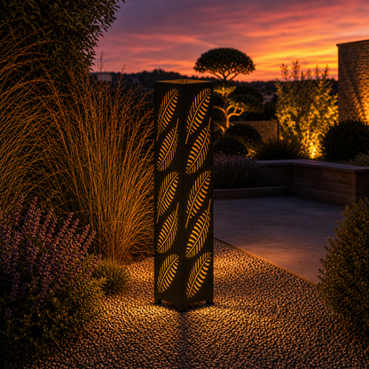 Design 143 outdoor decorative LED light column glowing at dusk in garden setting