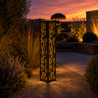 Design 163 outdoor decorative LED light column glowing at dusk in garden setting
