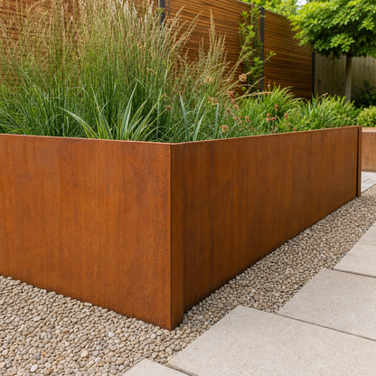 Low corten garden wall metal edging panels installed as a raised planting border in daylight