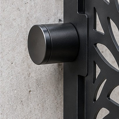 Cylindrical standoff cap holding a laser cut panel away from a wall
