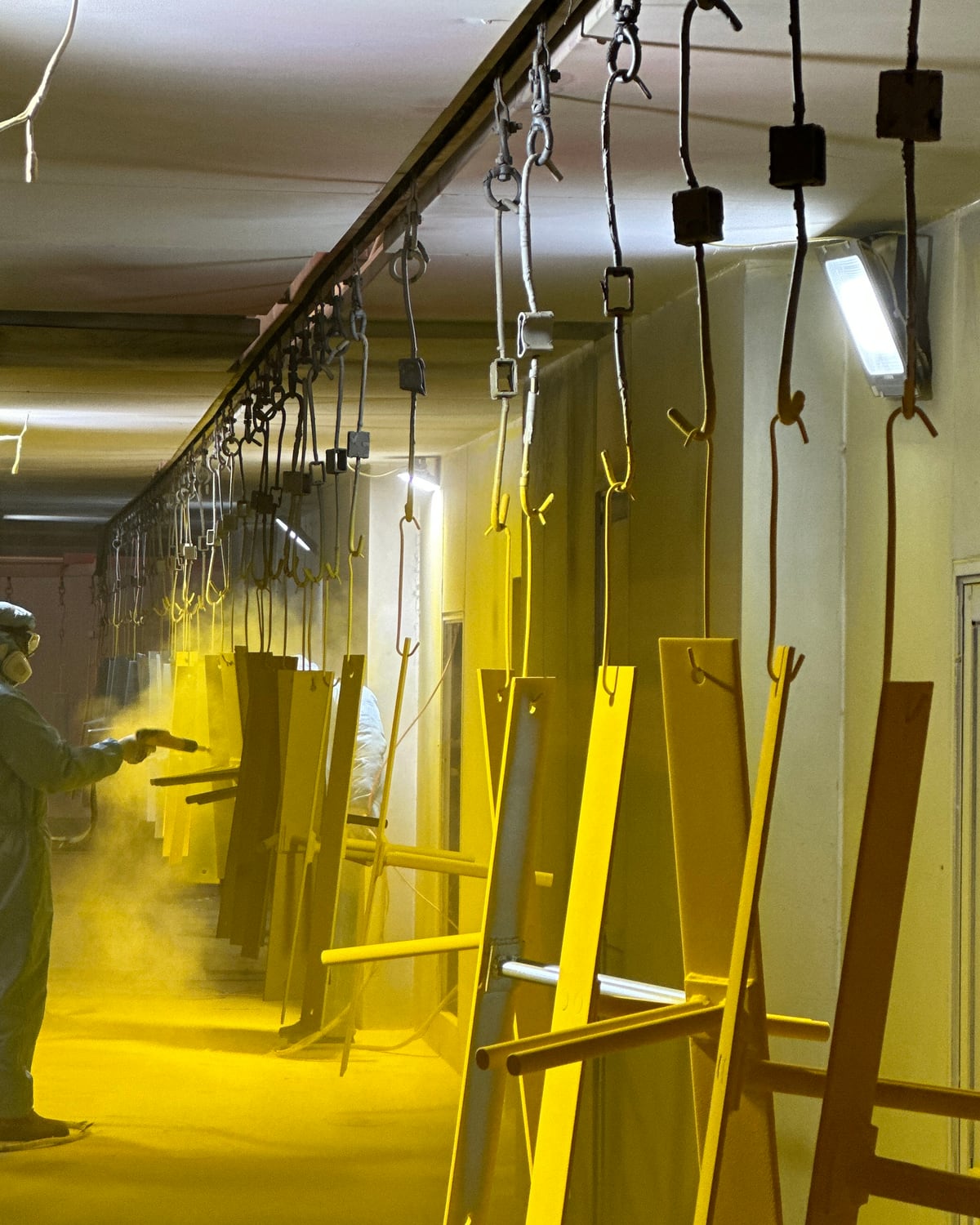 Powder coating line with custom metal parts in production